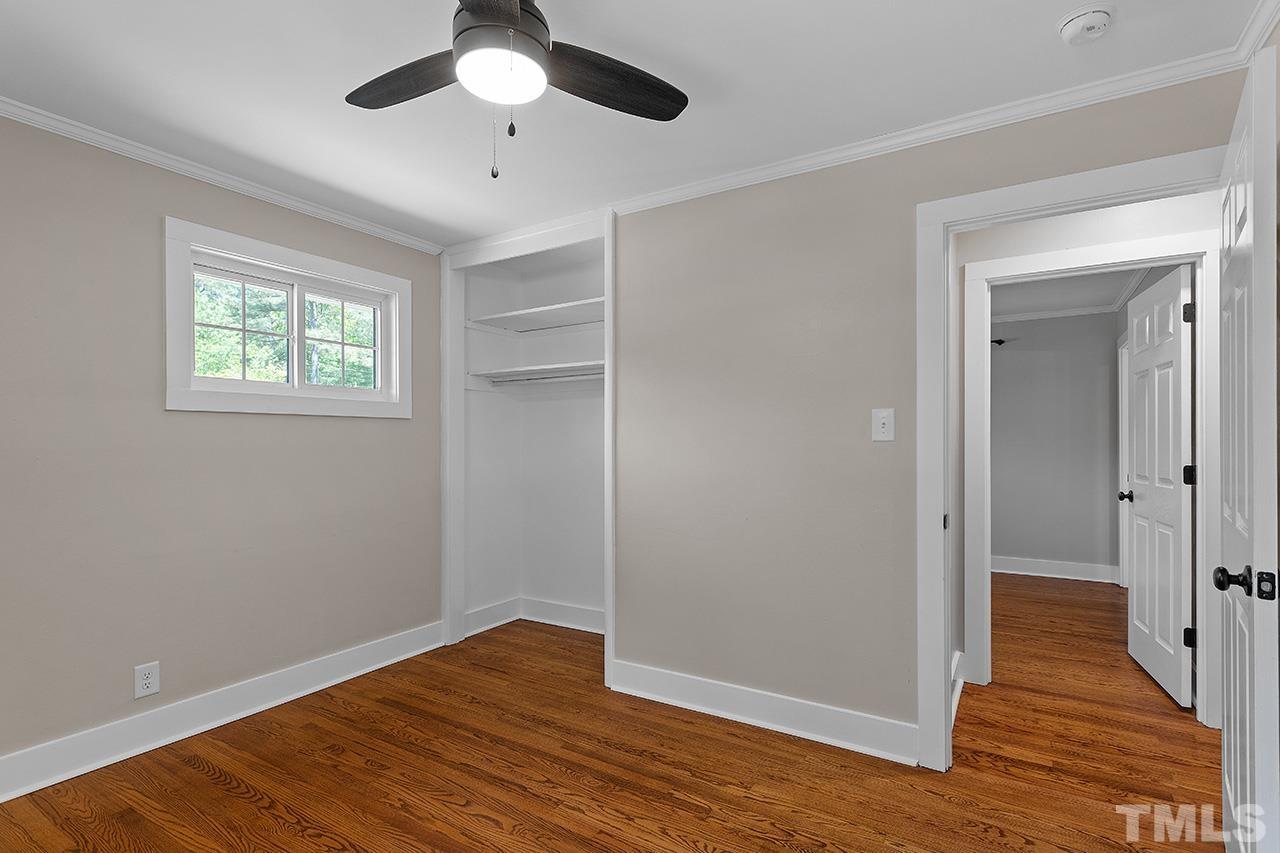 2609 Elmhurst Circle Raleigh, NC 27610 - Photo 24 of 34 an empty room with wooden floor cabinet and windows