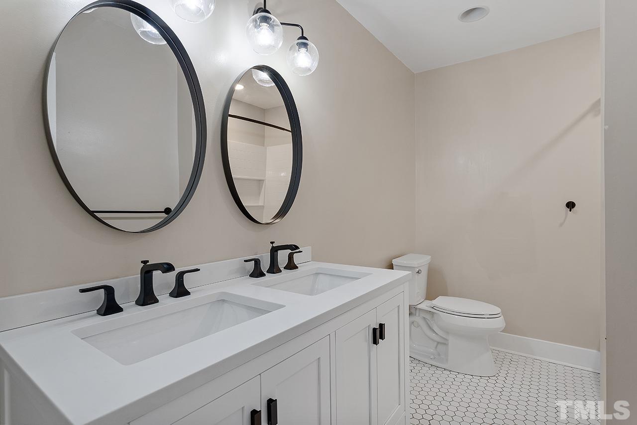 2609 Elmhurst Circle Raleigh, NC 27610 - Photo 26 of 34 a bathroom with a sink a toilet and a mirror