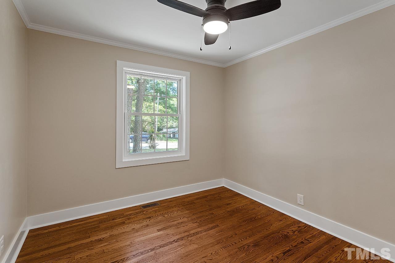 2609 Elmhurst Circle Raleigh, NC 27610 - Photo 27 of 34 a view of an empty room with wooden floor and a window