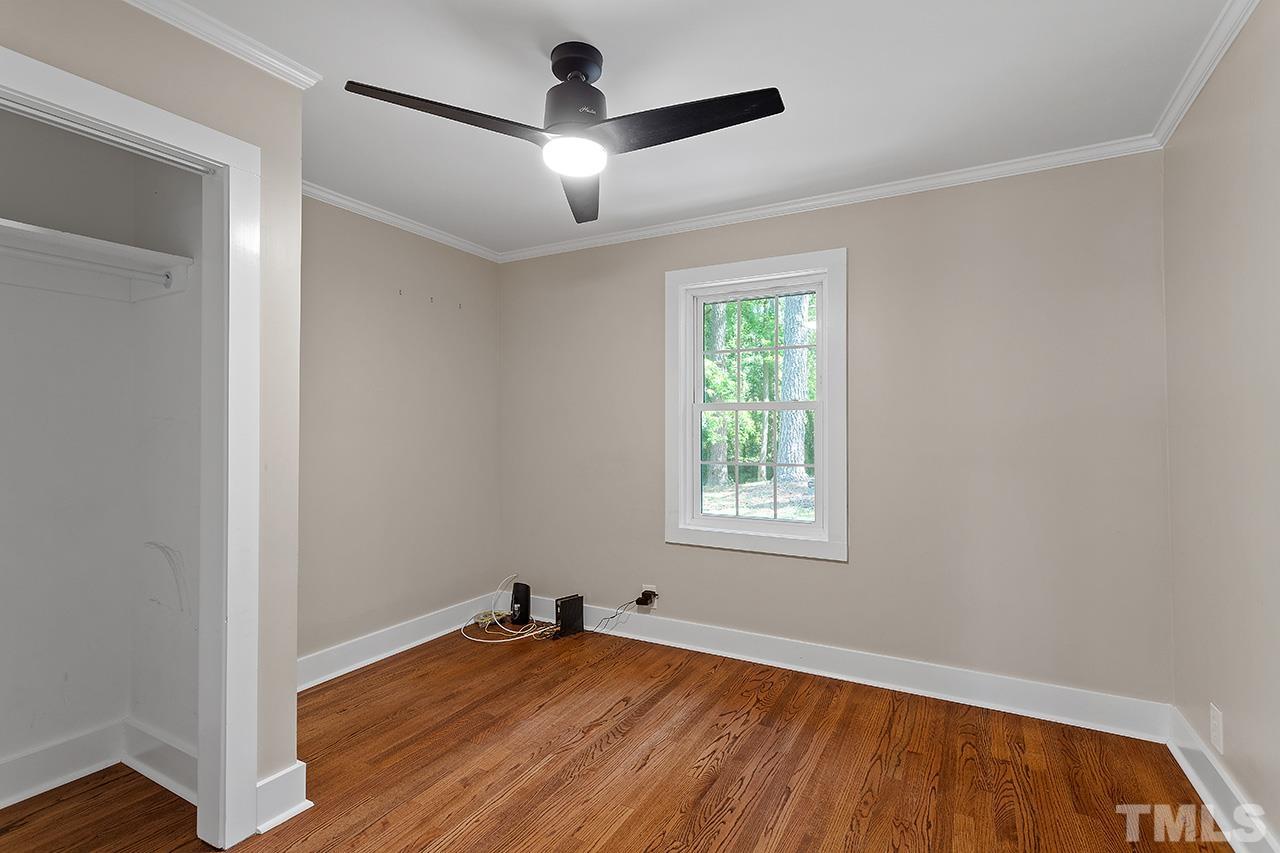 2609 Elmhurst Circle Raleigh, NC 27610 - Photo 28 of 34 an empty room with wooden floor chandelier fan and windows