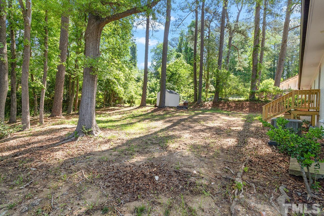 2609 Elmhurst Circle Raleigh, NC 27610 - Photo 33 of 34 a view of a yard with large trees and plants