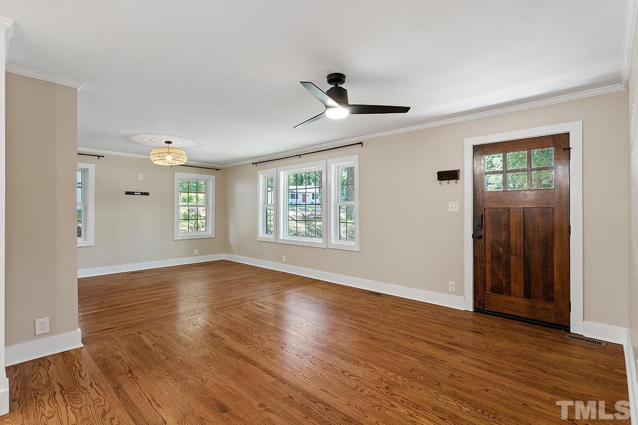 2609 Elmhurst Circle Raleigh, NC 27610 - Photo 4 of 34 a view of an empty room with wooden floor and a window