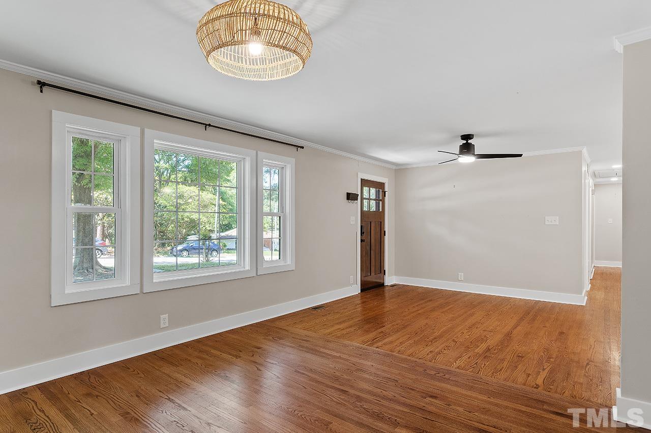 2609 Elmhurst Circle Raleigh, NC 27610 - Photo 5 of 34 an empty room with wooden floor and windows