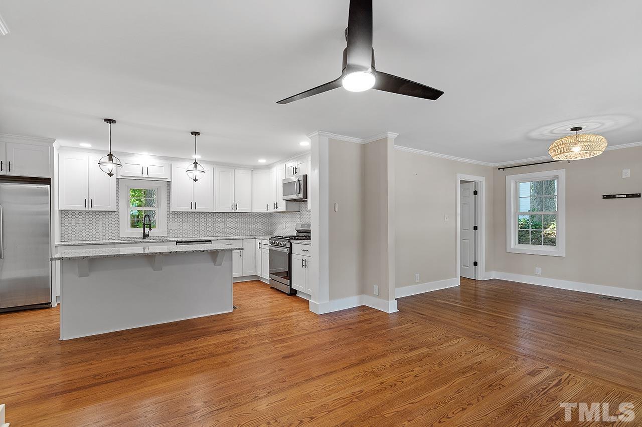 2609 Elmhurst Circle Raleigh, NC 27610 - Photo 7 of 34 a kitchen with stainless steel appliances granite countertop a refrigerator a sink dishwasher a stove and white cabinets with wooden floor