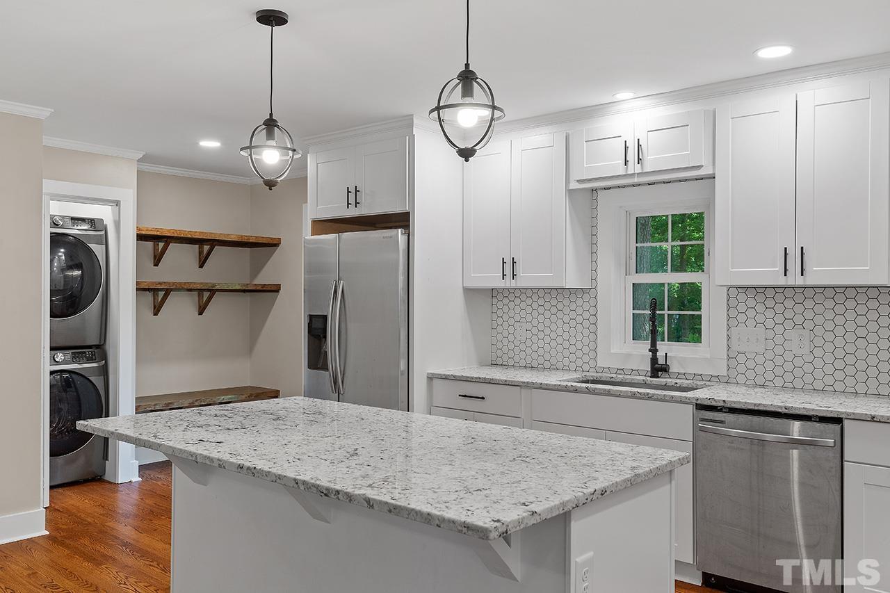 2609 Elmhurst Circle Raleigh, NC 27610 - Photo 9 of 34 a kitchen with stainless steel appliances granite countertop a sink a refrigerator a stove and a wooden floors