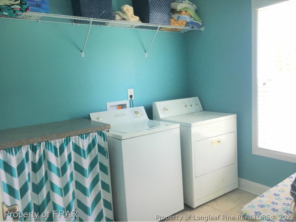 804 Raspberry Road Stedman, NC 28391 - Photo 14 of 34 a utility room with dryer and washer