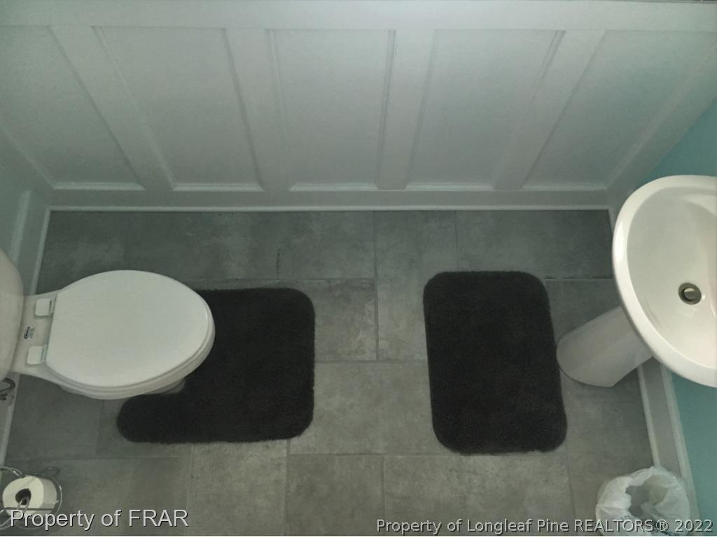 804 Raspberry Road Stedman, NC 28391 - Photo 16 of 34 a bathroom with a toilet and a mirror