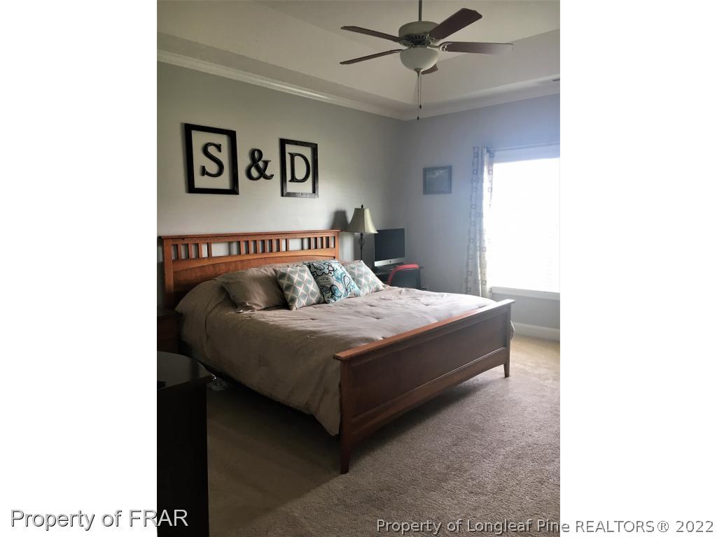 804 Raspberry Road Stedman, NC 28391 - Photo 20 of 34 a bedroom with a bed and painting on the wall