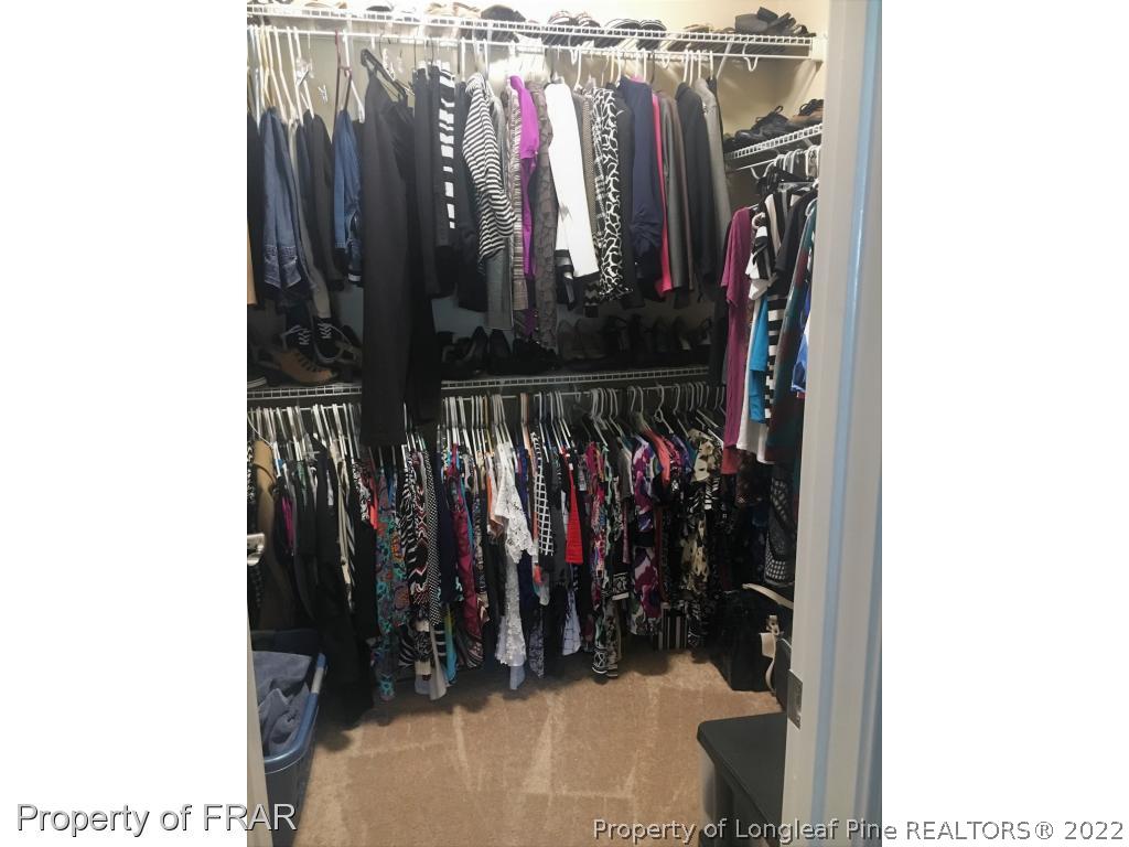 804 Raspberry Road Stedman, NC 28391 - Photo 22 of 34 a view of walk in closet with clothes