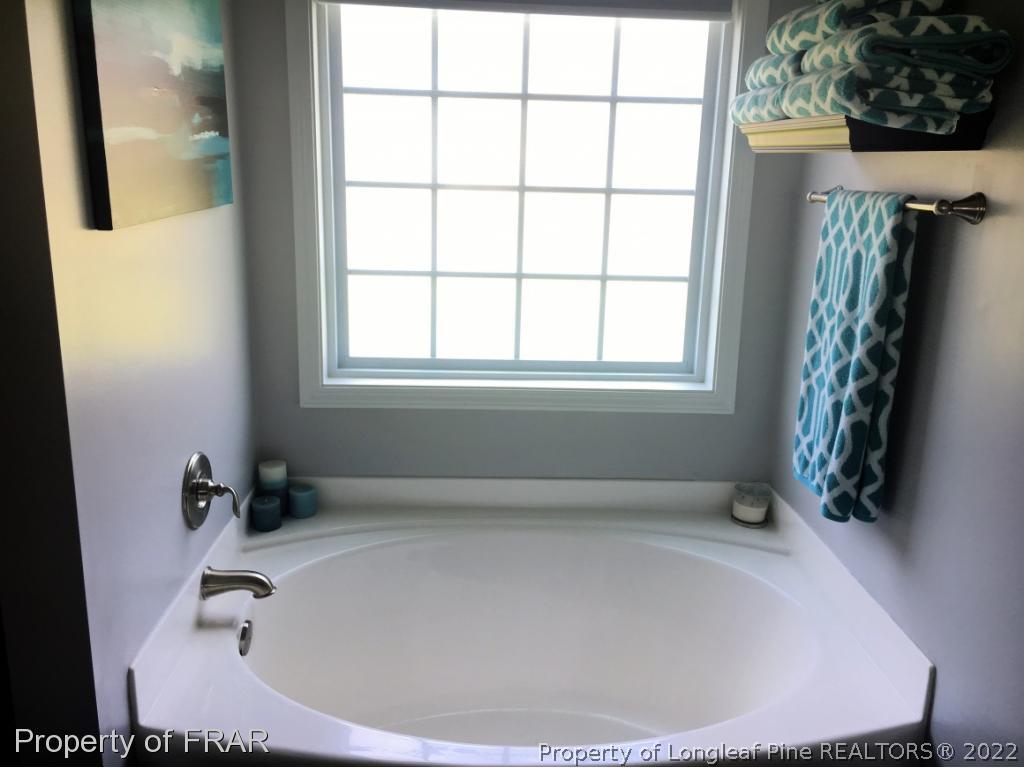 804 Raspberry Road Stedman, NC 28391 - Photo 23 of 34 a bathroom with a tub