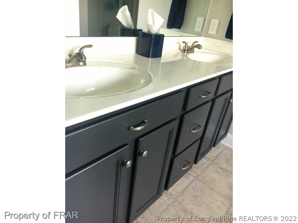 804 Raspberry Road Stedman, NC 28391 - Photo 24 of 34 a bathroom with a double vanity sink and a mirror