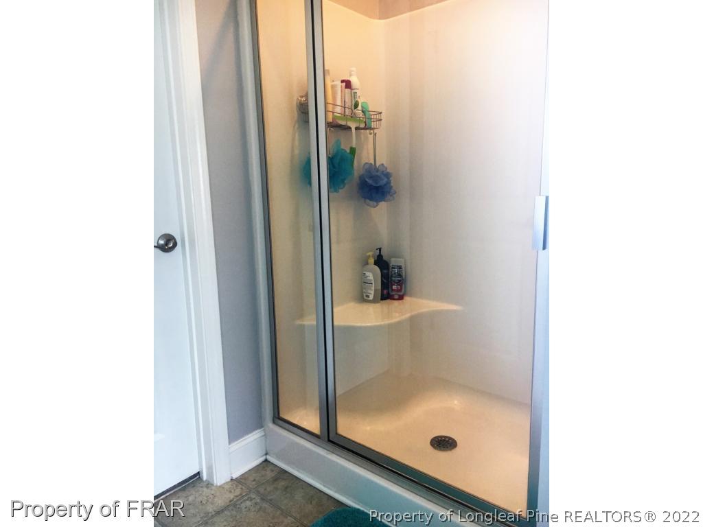 804 Raspberry Road Stedman, NC 28391 - Photo 26 of 34 a bathroom with a glass shower door