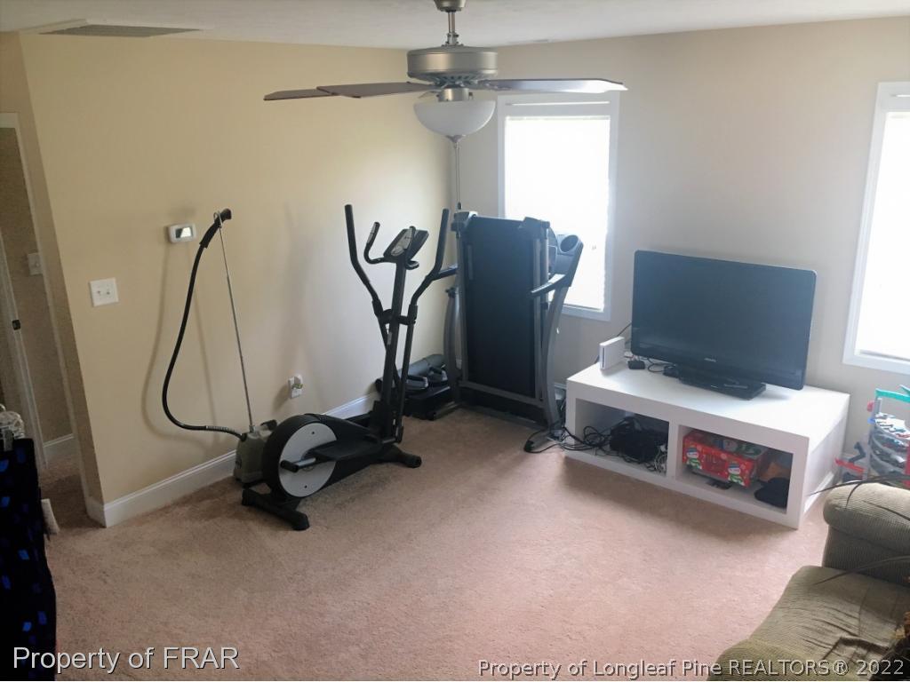 804 Raspberry Road Stedman, NC 28391 - Photo 28 of 34 a room with gym equipment and windows