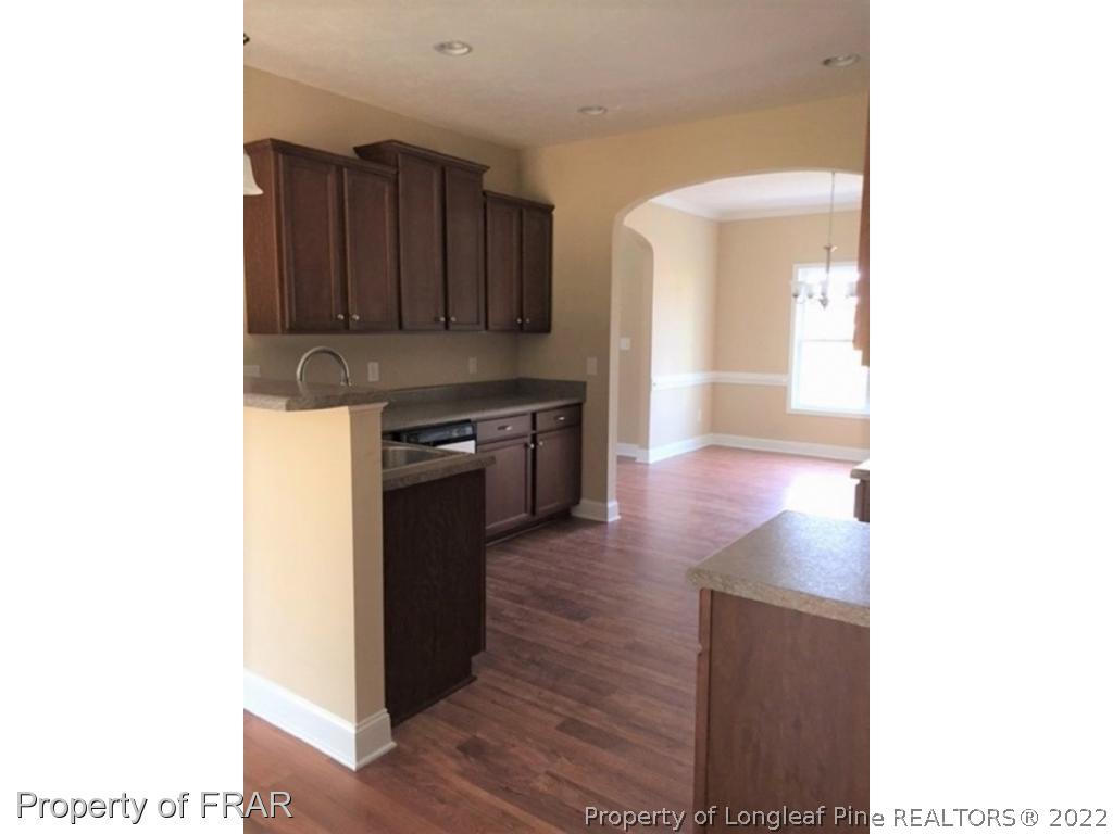 804 Raspberry Road Stedman, NC 28391 - Photo 7 of 34 a kitchen with wooden floors and a stove