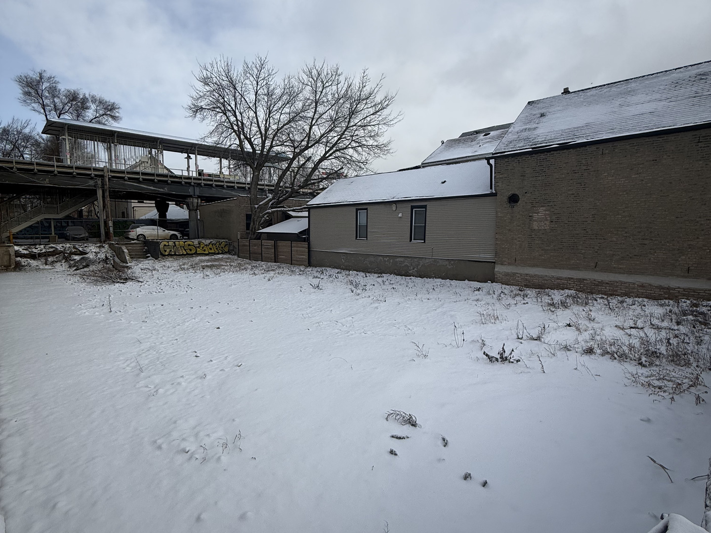2050 West 21st Street Chicago, IL 60608 - Photo 4 of 7 a backyard of a house with wooden fence and trees