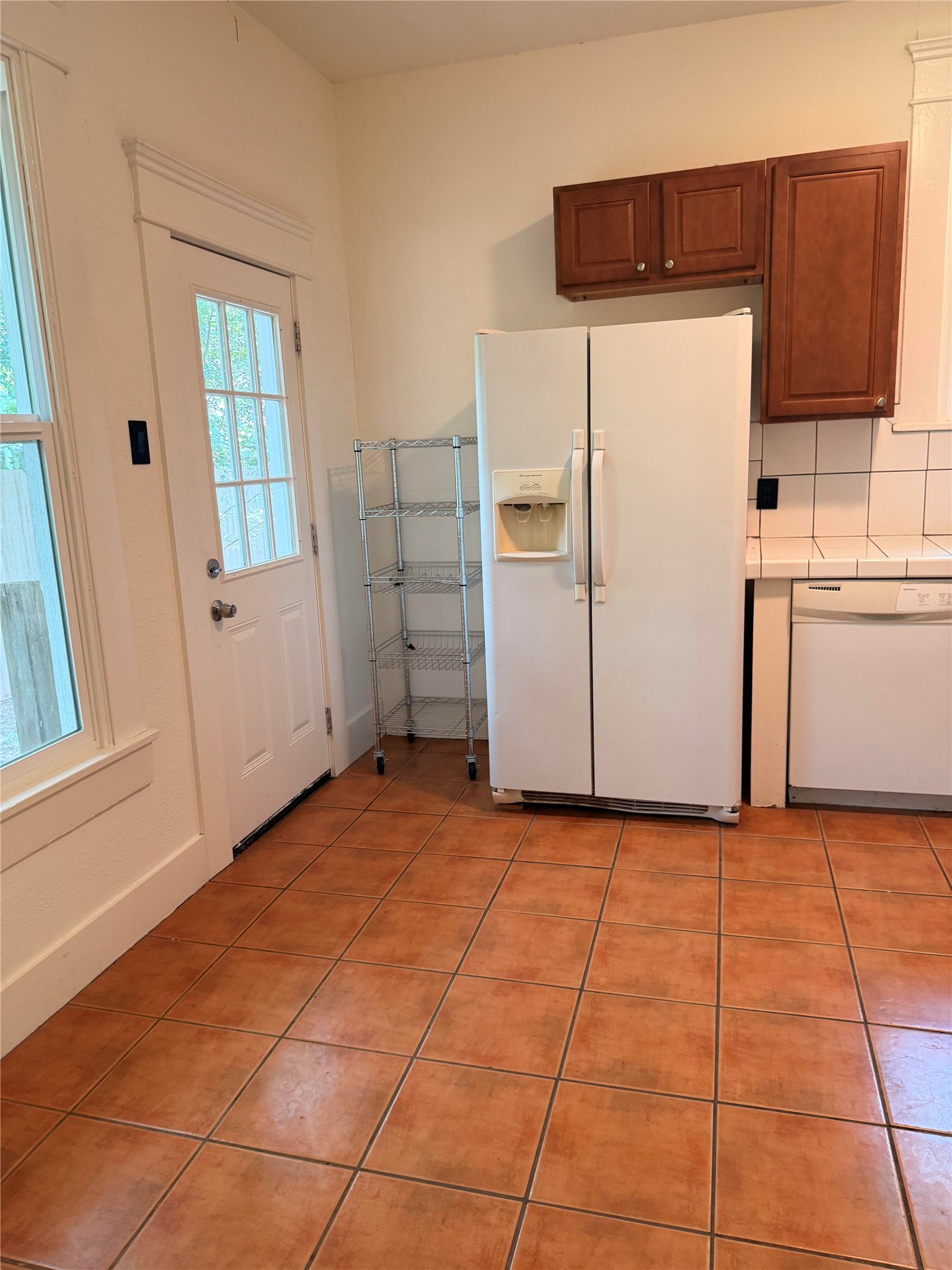 1136 Eleanor Street Austin, TX 78721 - Photo 8 of 30 Functional kitchen with ample appliance space and warm tiled flooring.