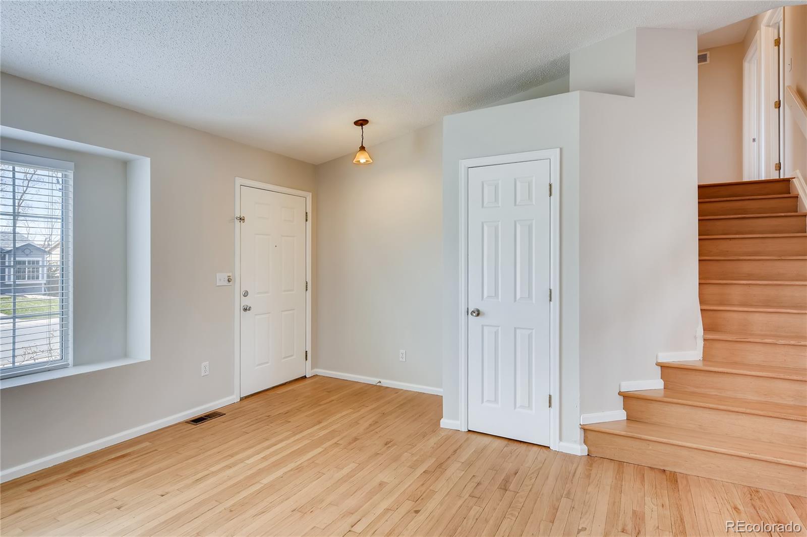 9684 South Castle Ridge Circle Highlands Ranch, CO 80129 - Photo 5 of 28 a view of entryway with wooden floor