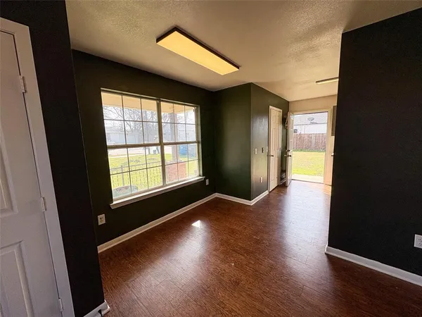 a view of hallway with wooden floor