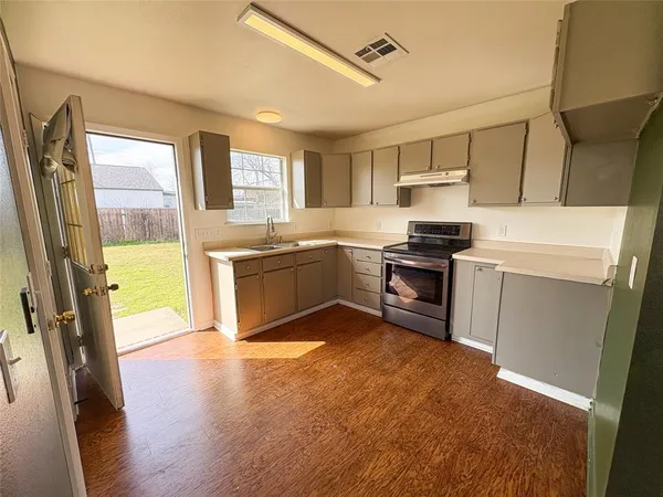 a kitchen with stainless steel appliances granite countertop a stove refrigerator and a refrigerator