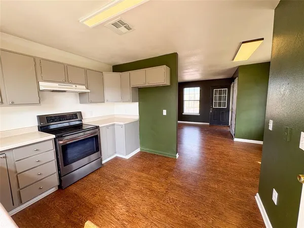 a kitchen with a refrigerator and a sink
