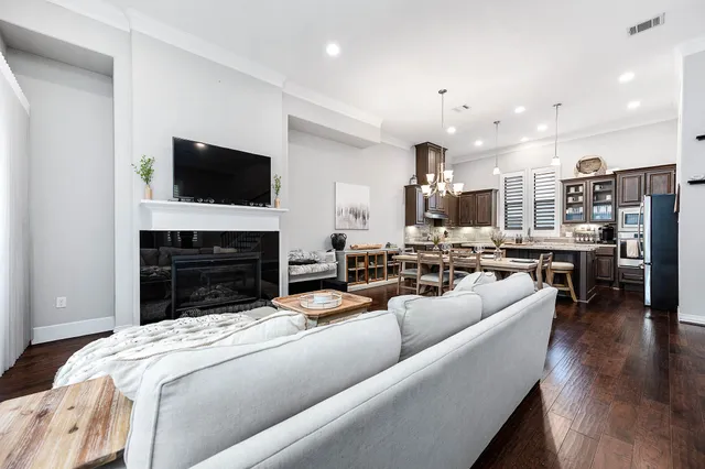 a living room with lots of furniture and view of kitchen