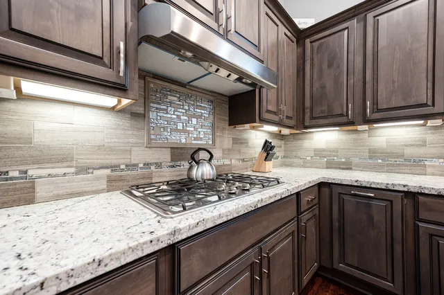 a kitchen with stainless steel appliances granite countertop a sink and dishwasher