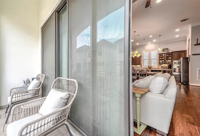 a view of a livingroom with wooden floor and windows