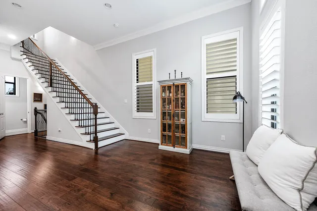 a view of a hallway with wooden floor and a window
