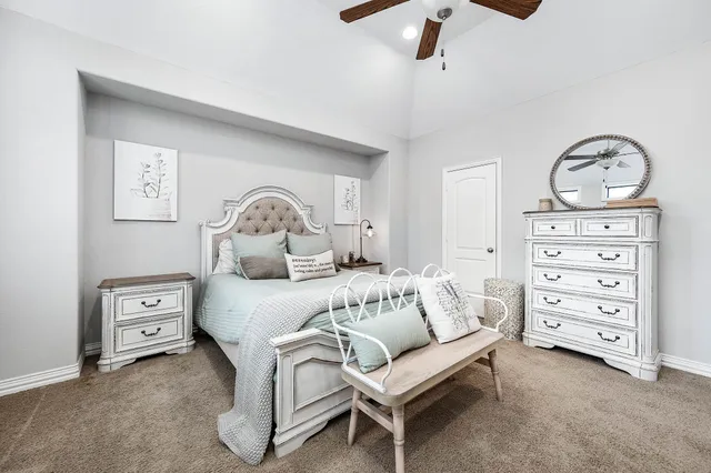 a bedroom with a bed and ceiling fan