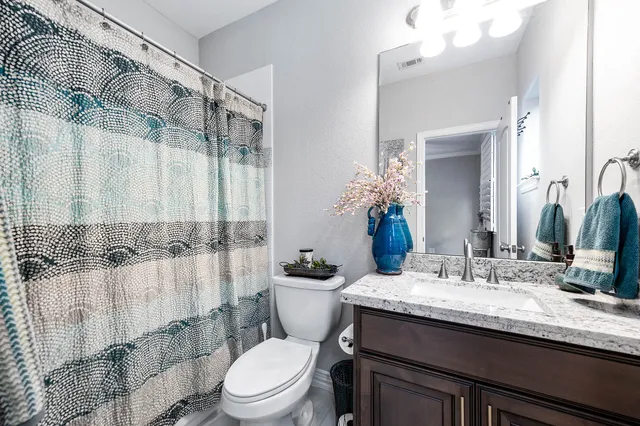 a living room with furniture a fireplace and a chandelier