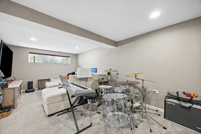 a living room with furniture a flat screen tv and a window