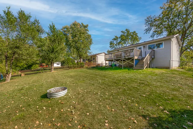 a view of a house with yard and sitting area