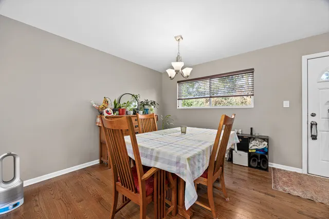 a view of a dining room with furniture wooden floor and chandelier