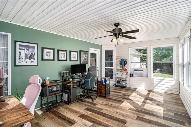 a work room with furniture and a large window
