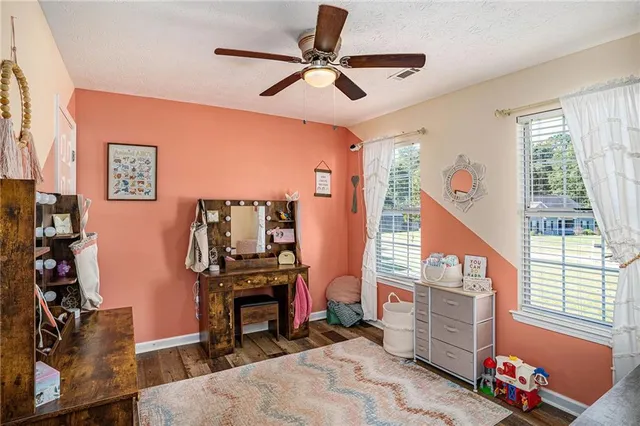 a bedroom with furniture and a window