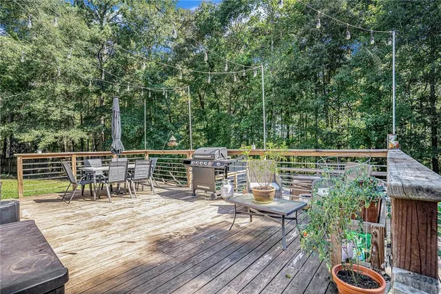 a view of a chairs and table on the wooden deck