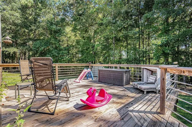 a view of roof deck with chair and tables