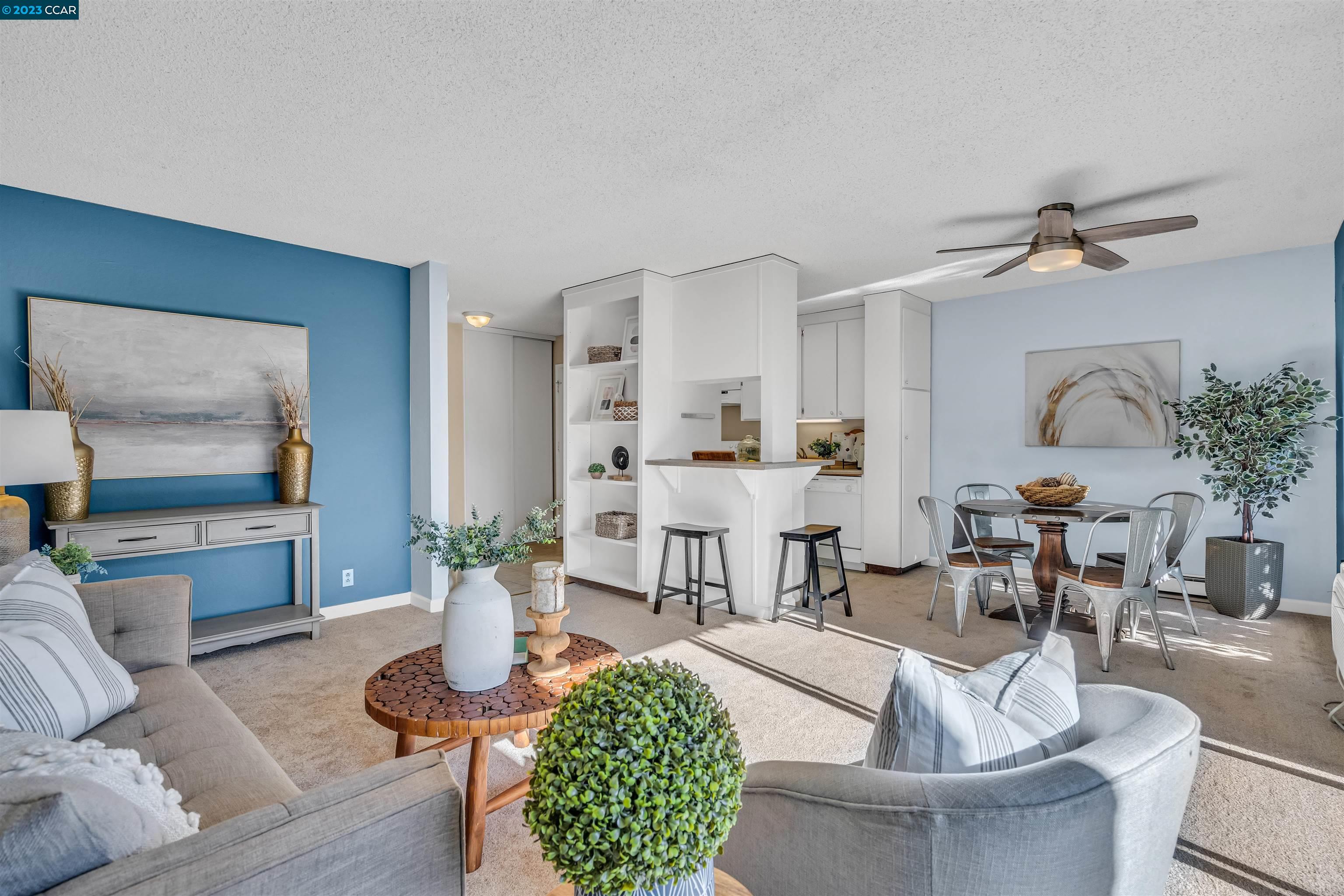 a living room with furniture potted plant and a fireplace