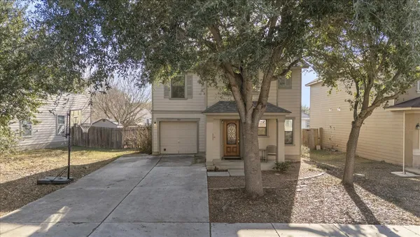 a view of a house with a tree