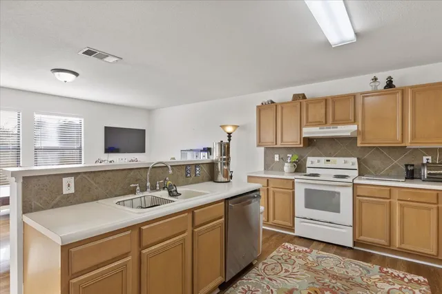 a kitchen with a sink stove and cabinets
