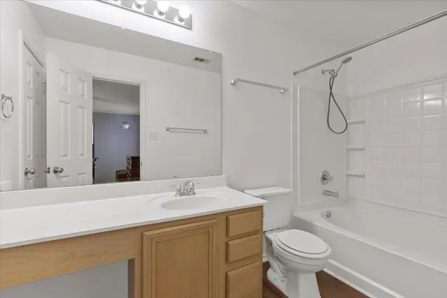 a bathroom with a sink toilet vanity and shower