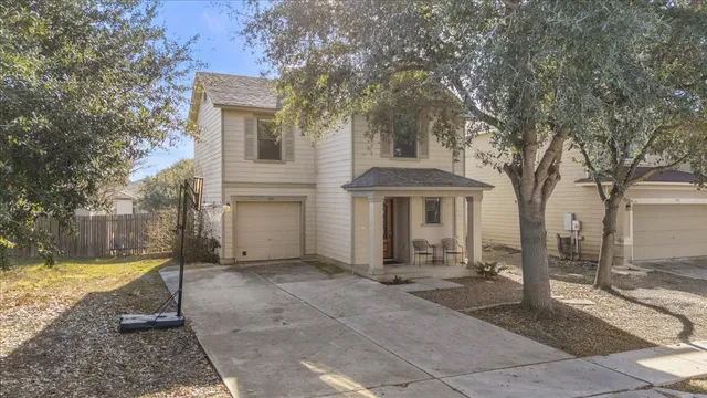 a view of a house with backyard and sitting area