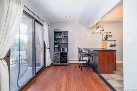 a view of a hallway with wooden floor and furniture