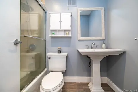 a white toilet sitting next to a bathroom sink