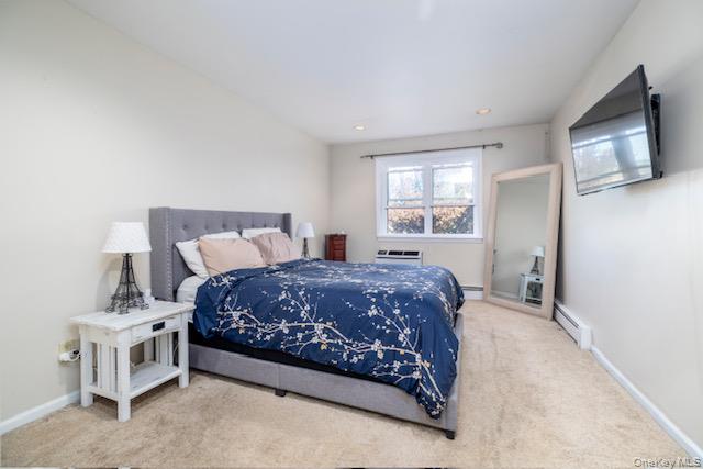 214 Westend Avenue, Unit 6C Freeport, NY 11520 - Photo 14 of 17 a bedroom with a bed flat screen tv and window