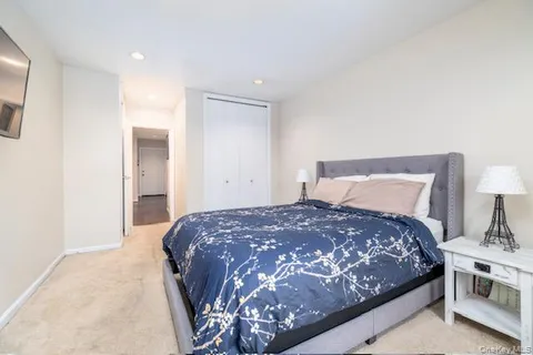 a bedroom with a bed and a lamp with the table