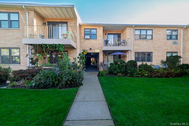 214 Westend Avenue, Unit 6C Freeport, NY 11520 - Photo 2 of 17 a front view of a house with garden