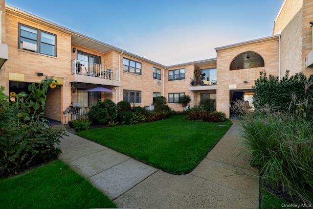 214 Westend Avenue, Unit 6C Freeport, NY 11520 - Photo 3 of 17 a front view of a house with a yard