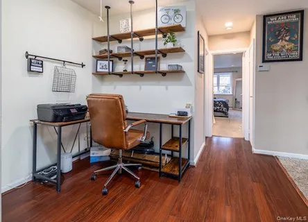 a view of a workspace with furniture and wooden floor