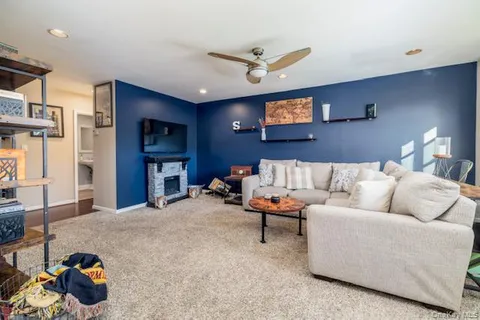 a living room with furniture and a ceiling fan